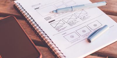 notebook-beside-the-iphone-on-table-196644